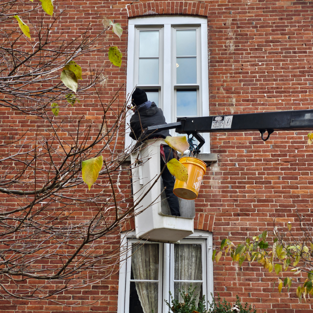 Window installation during a historic brick home renovation.