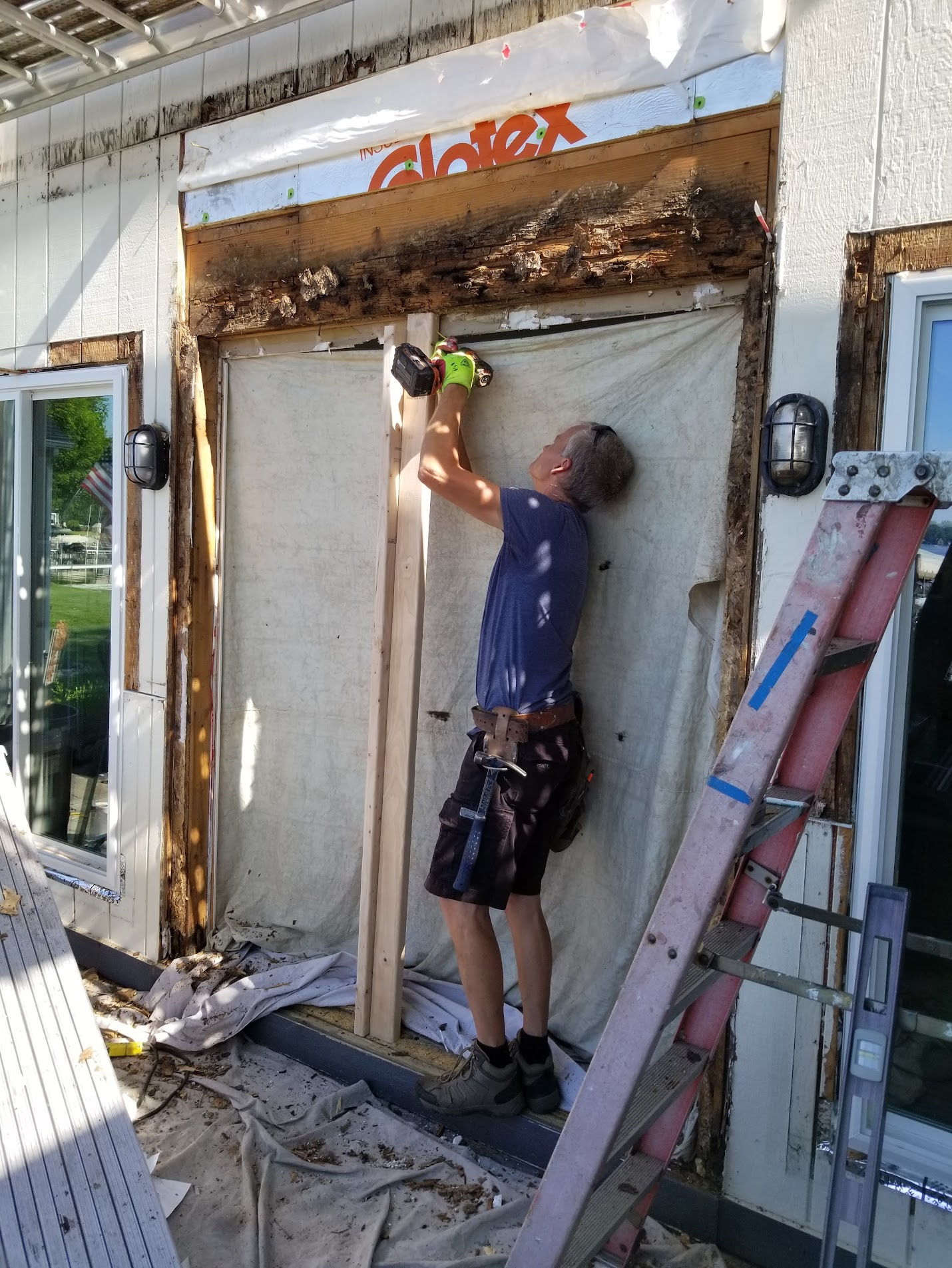 Lakeview installer repairing rotted framing above a patio door opening