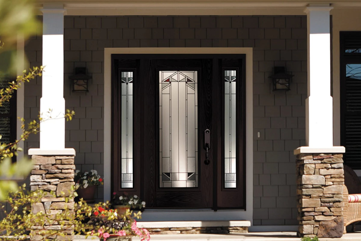 Custom woodgrain entry door with decorative glass and sidelites