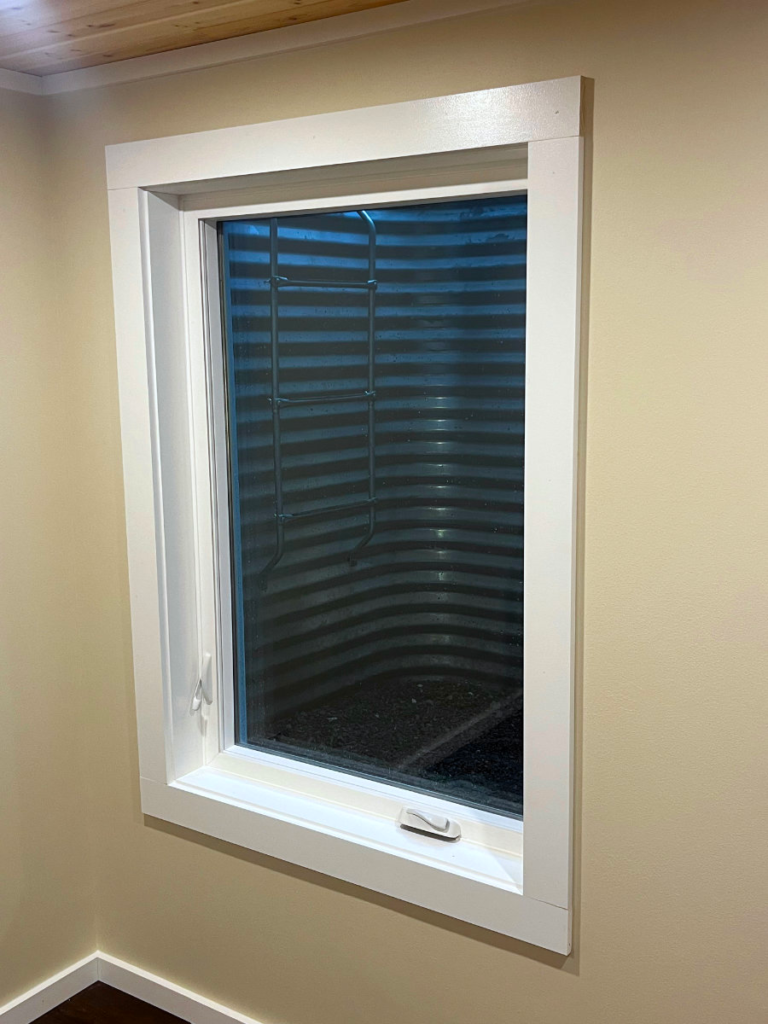 Basement egress window installation with exterior window well
