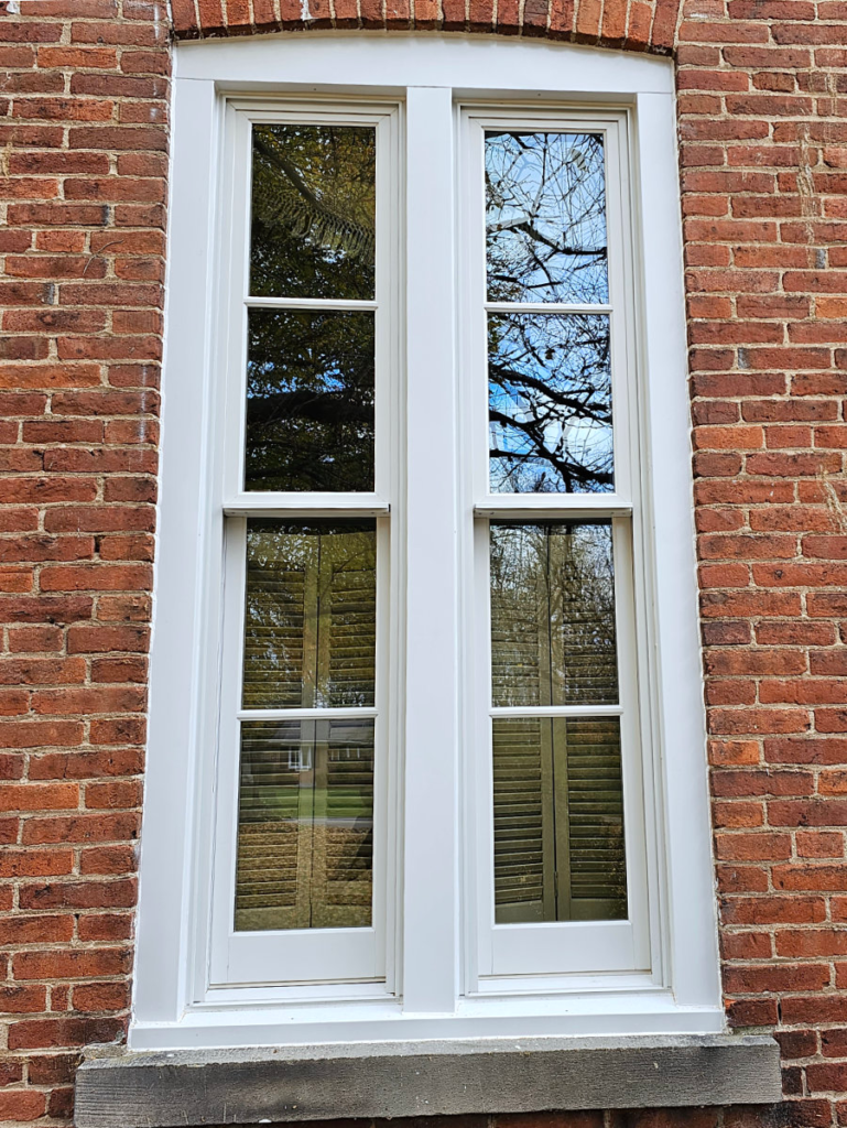 Replacement windows with finished exterior trim on an 1865 Coldwater home